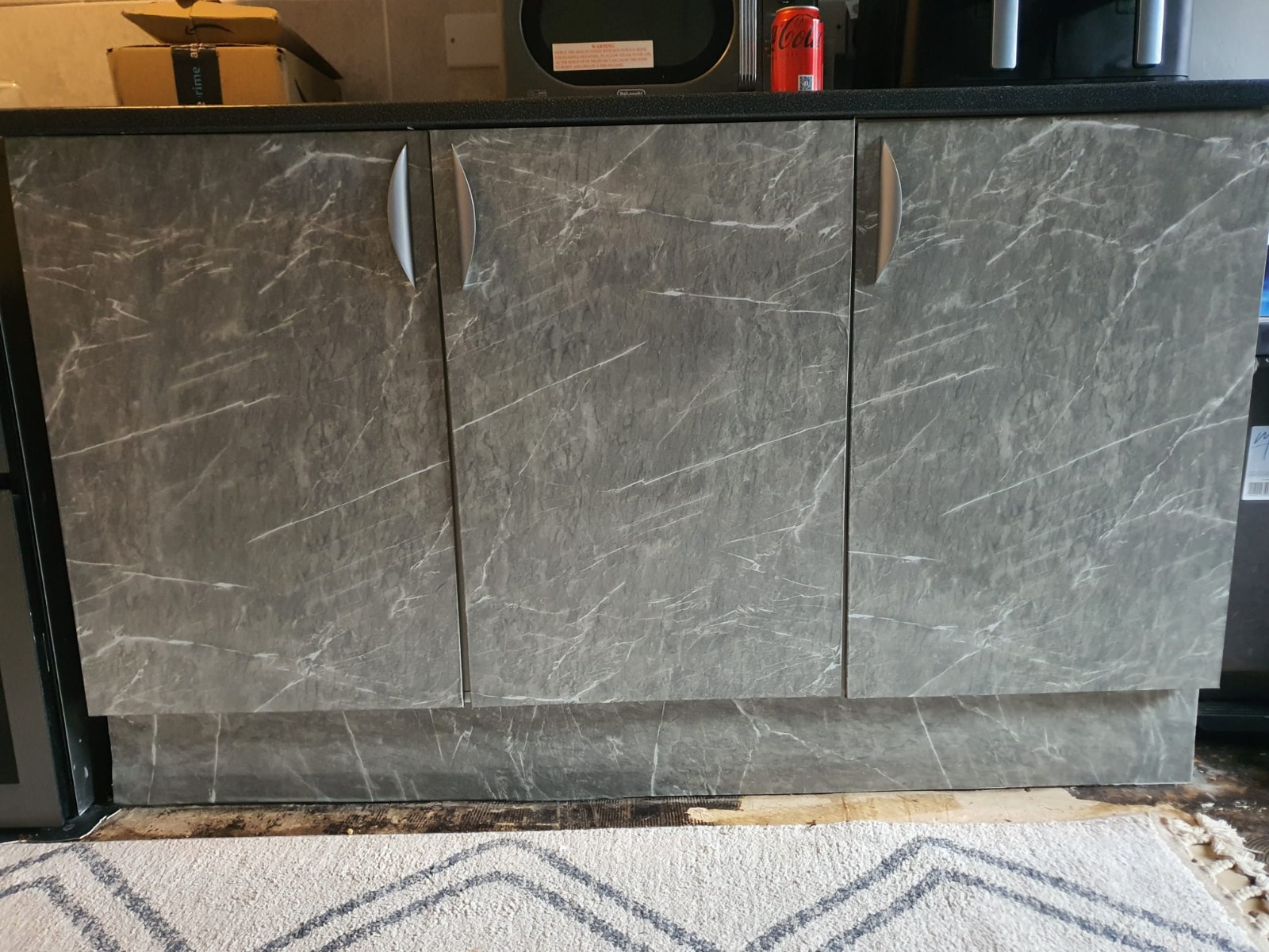 Modern kitchen with marble-effect units and new flooring — South Wales install