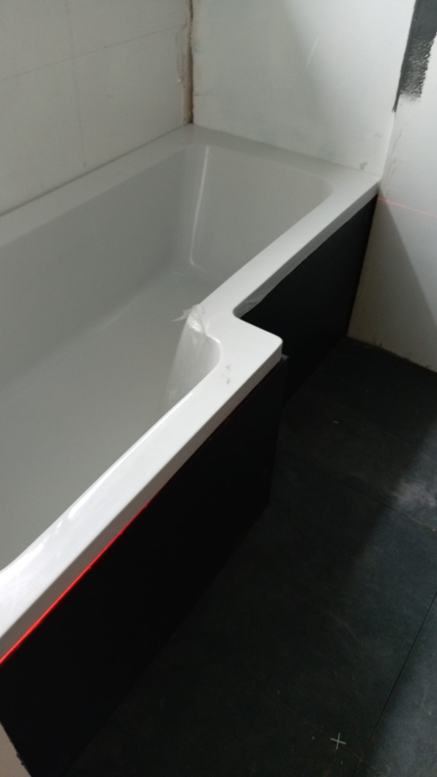 Freshly fitted white bath ready for tiling — South Wales bathroom install